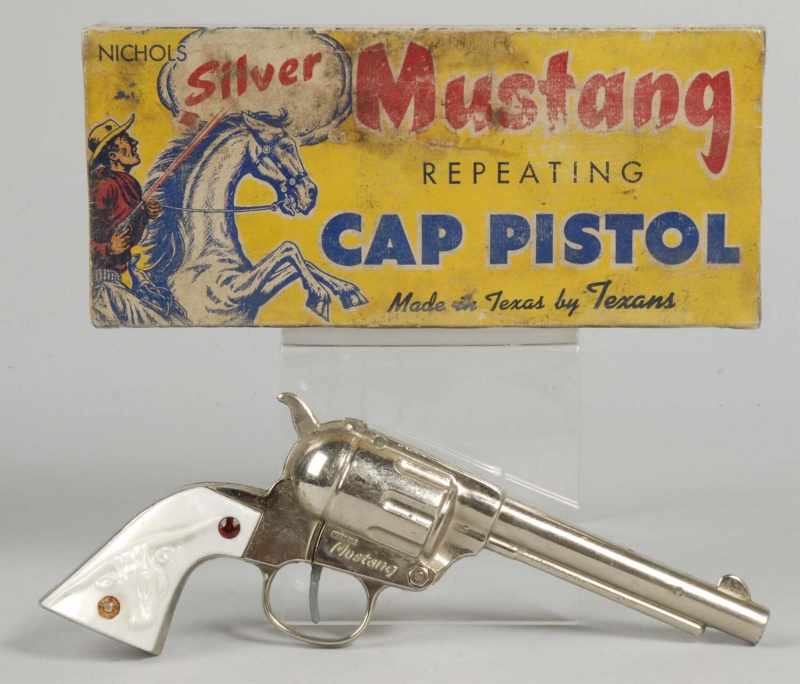 Appraisal: Nichols Silver Mustang Cap Gun in Box Description Cap fired