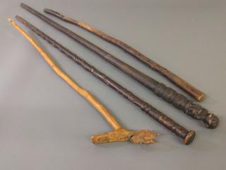 Appraisal: Carved cane Miscellaneous grouping of four wood carved canes As