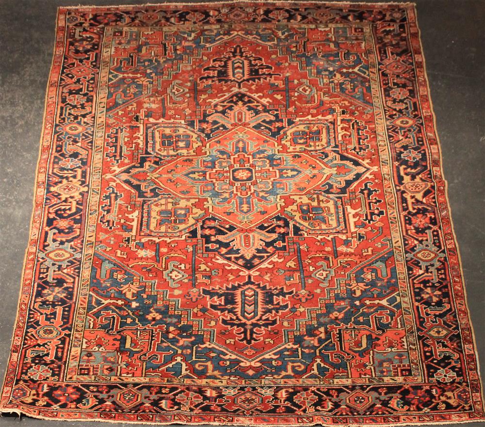 Appraisal: HERIZ RUG central medallion with corner spanderels surrounded by multiple