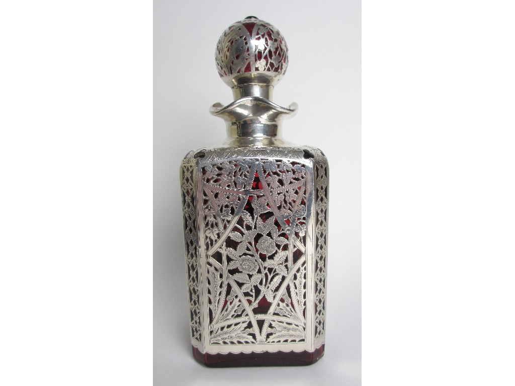 Appraisal: A Continental silver mounted red glass decanter with pierced foliate