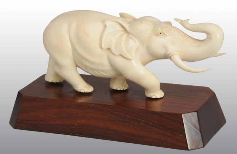 Appraisal: Solid Ivory Elephant Statue Description Statue sits on wooden base