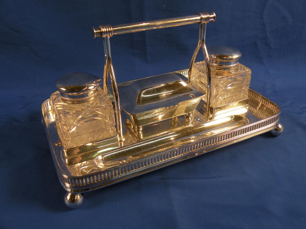 Appraisal: A silver plated ink stand with carrying handle the rectangular