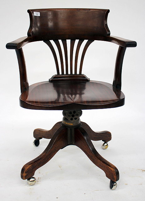 Appraisal: A ROTATING HARDWOOD DESK CHAIR the horseshoe shaped back with