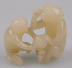 Appraisal: A Chinese carved jade group of two monkeys fighting over