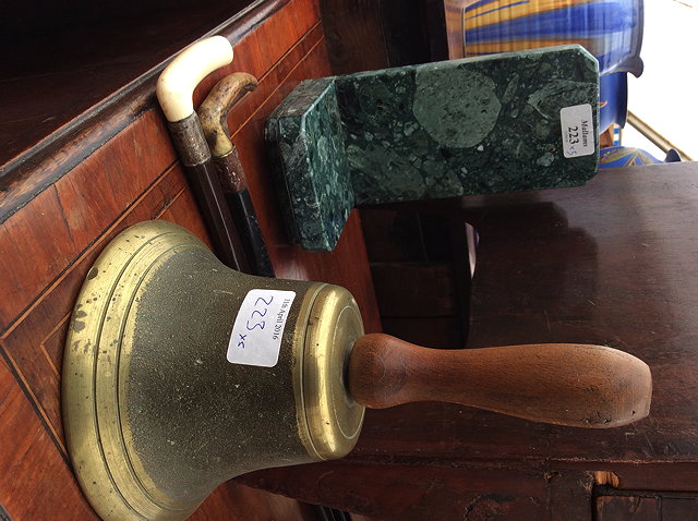 Appraisal: A PAIR OF GREEN HARDSTONE BOOKENDS an old brass hand