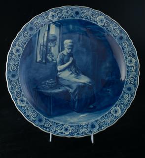 Appraisal: Delft Porcelain Charger Depicting interior scene of woman sewing bearing