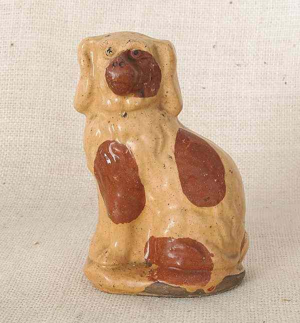 Appraisal: Pennsylvania redware spaniel th c with yellow glaze and red