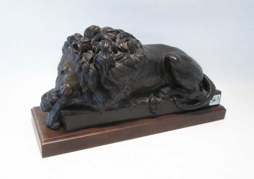 Appraisal: BRONZE WILDLIFE SCULPTURE a recumbent lion on wood plinth H