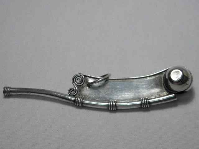 Appraisal: European silverplate boatswain's whistle with reeding scrollwork and a loop