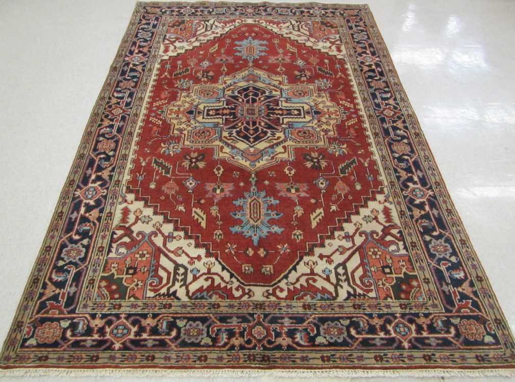 Appraisal: HAND KNOTTED ORIENTAL CARPET Persian Serapi design composed of central