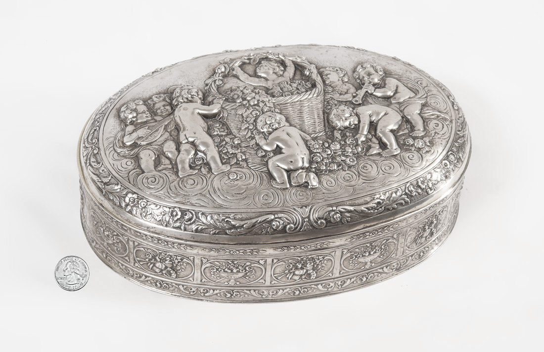 Appraisal: LARGE GERMAN SILVER EMBOSSED BOX Hinged lid with figural putti