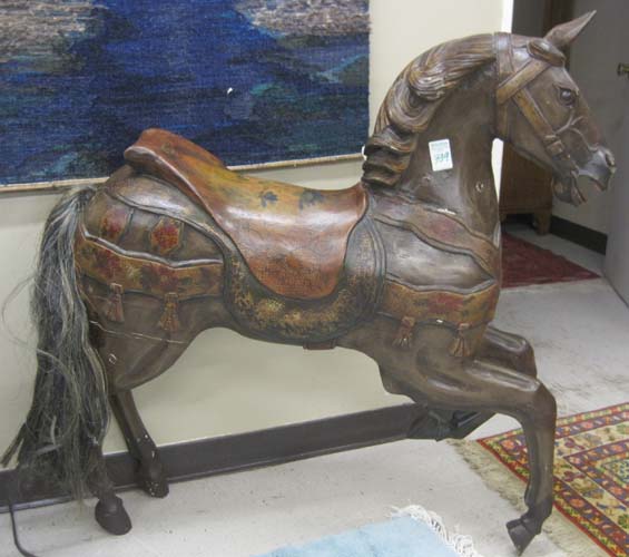 Appraisal: A CARVED AND PAINTED WOOD 'CAROUSEL' HORSE inside row jumper