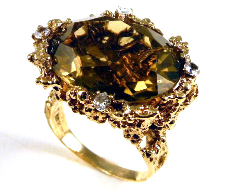 Appraisal: SMOKY QUARTZ AND TEN KARAT GOLD RING centering an oval-cut