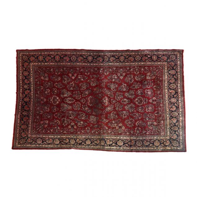 Appraisal: INDO SAROUK CARPET Red field with repeating floral motif dark