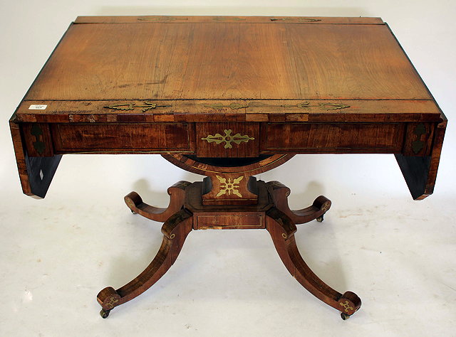 Appraisal: A REGENCY ROSEWOOD AND BRASS INLAID PEDESTAL SOFA TABLE with