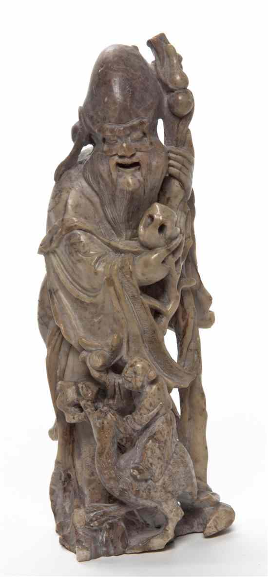 Appraisal: A Chinese Carved Soapstone Figure of Shoulao depicted standing holding