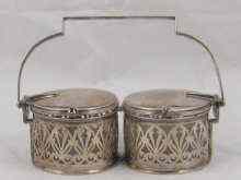 Appraisal: A silver plated double preserve pot with hinged lids operated