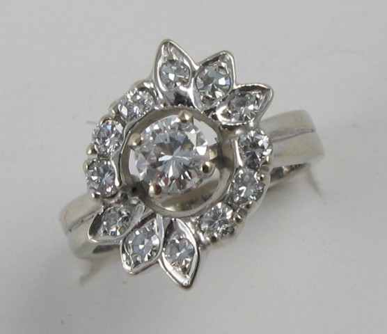 Appraisal: DIAMOND AND FOURTEEN KARAT WHITE GOLD RING centering a round