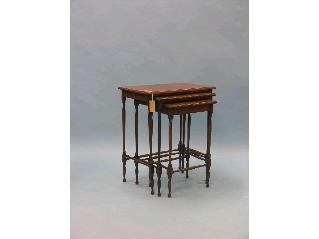 Appraisal: An Edwardian mahogany nest of three tables satinwood cross-banded throughout