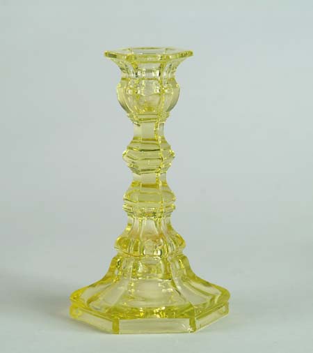 Appraisal: THREE YELLOW SANDWICH GLASS CANDLESTICKS Two with loop form bases