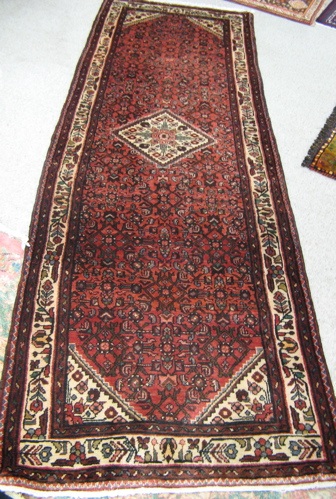 Appraisal: PERSIAN CORRIDOR CARPET Hamadan tribal villages region central flower-filled ivory