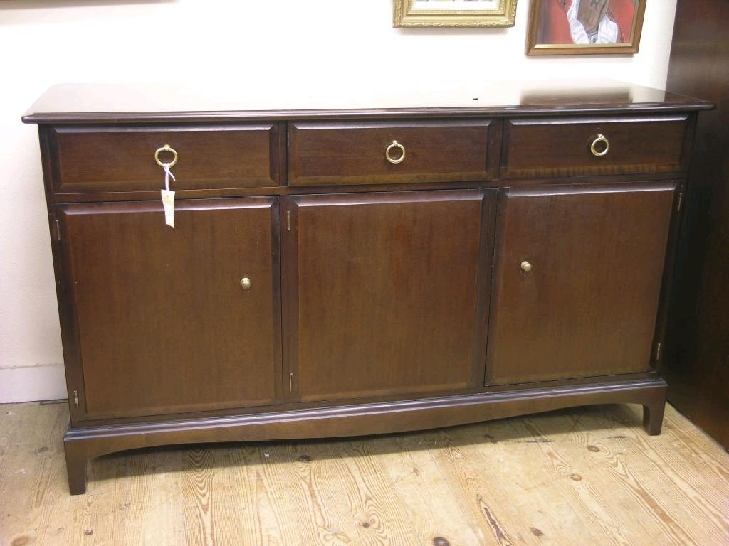 Appraisal: A Stag Minstrel sideboard three drawers above three cupboards bracket