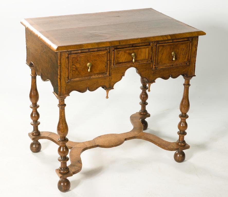 Appraisal: WALNUT LOWBOY LATE th CENTURY AND LATER the moulded feather-banded