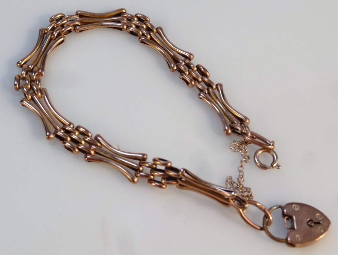 Appraisal: A gate bracelet with inverted and straight bars with padlock