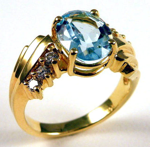 Appraisal: BLUE TOPAZ AND DIAMOND RING k yellow gold centering an