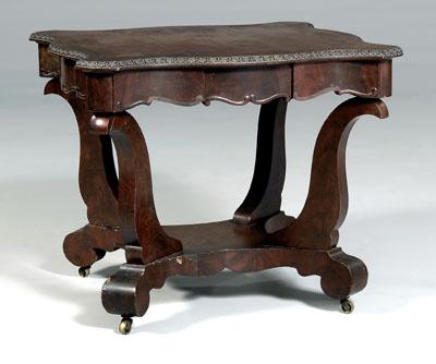 Appraisal: American classical center table mahogany with cartouche-form top over conforming