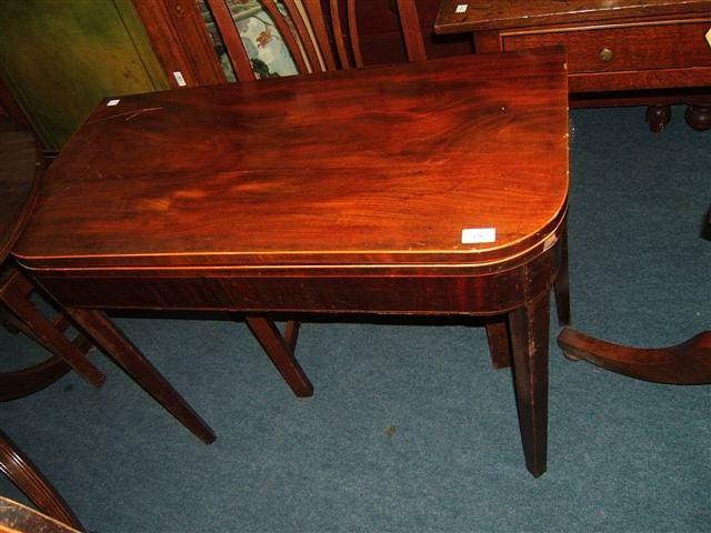 Appraisal: A Georgian mahogany fold over tea table with square tapering