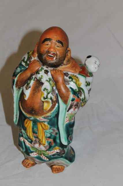 Appraisal: A JAPANESE KUTANI PORCELAIN MODEL OF HOTEI with child carried