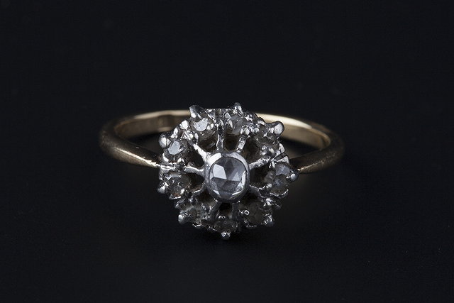 Appraisal: A DIAMOND CLUSTER RING the pierced circular setting highlighted with