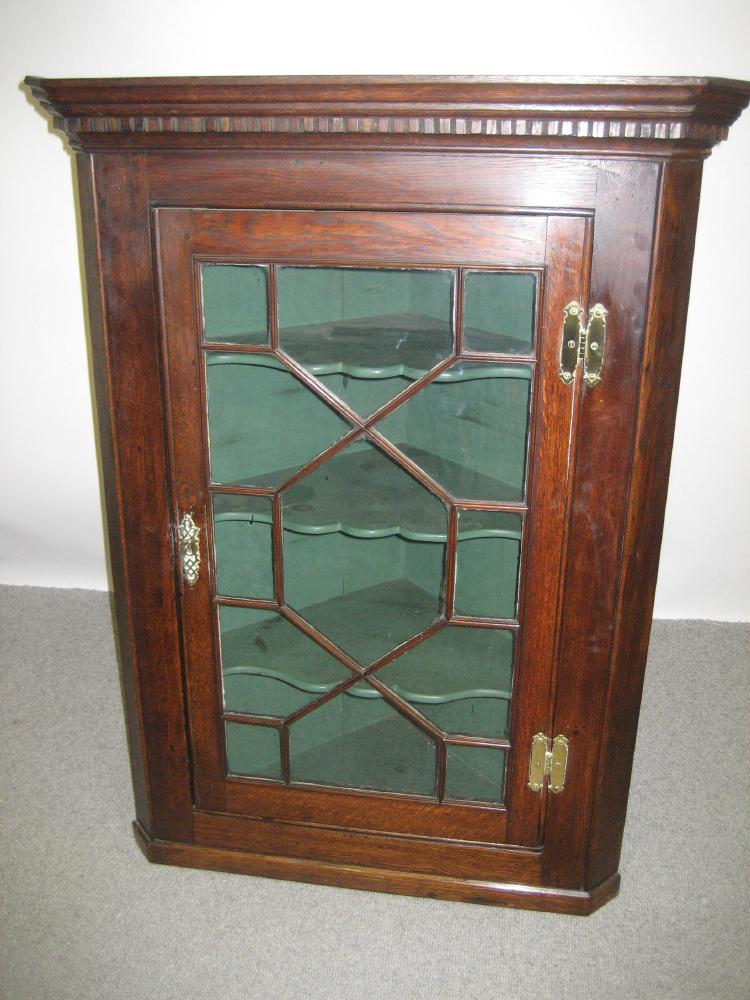 Appraisal: A GEORGE III GLAZED OAK CORNER CUPBOARD late th century