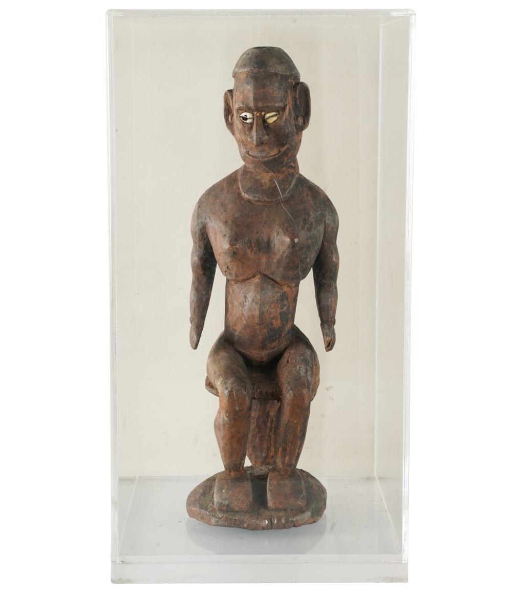 Appraisal: AFRICAN CARVED WOOD SEATED FIGUREin lucite case inches high the