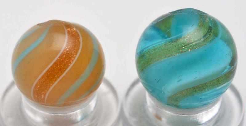 Appraisal: Lot of Lutz Marbles Description Smaller marble is a custard