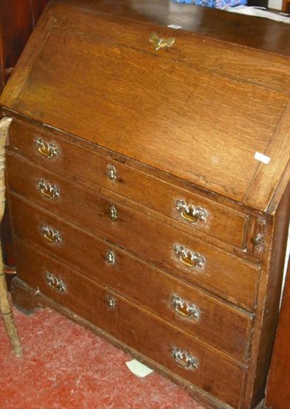 Appraisal: An oak bureau fitted with four long graduated drawers