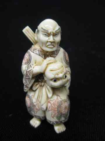 Appraisal: Carved Ivory Netsuke of a Man holding a head fancy