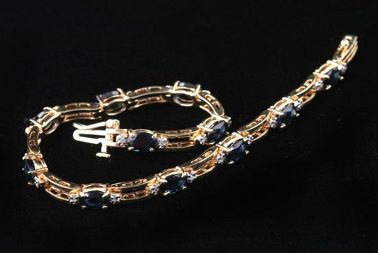 Appraisal: K YELLOW GOLD SAPPHIRE AND DIAMOND FLEXIBLE LINK BRACELET Eleven