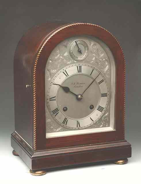 Appraisal: AN EDWARDIAN MAHOGANY MANTEL CLOCK the arched silvered dial with