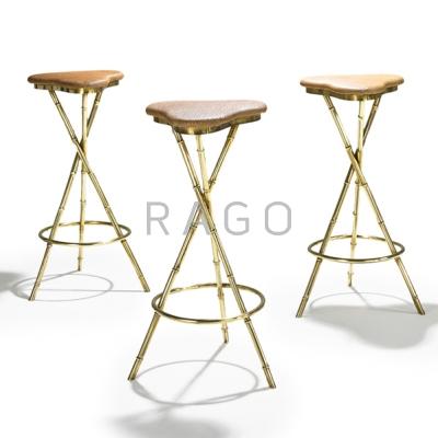 Appraisal: JACQUES ADNET Three bar stools France s Brass vinyl Unmarked