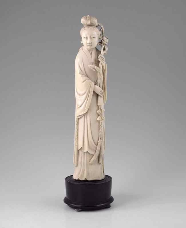 Appraisal: CHINESE CARVED IVORY FIGURAL MAIDEN Figural maiden holding branch with