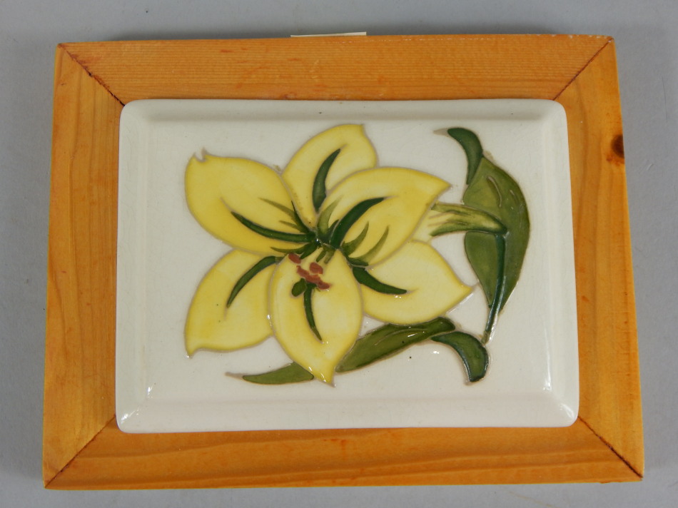 Appraisal: A Moorcroft rectangular pot lid decorated with a yellow flower