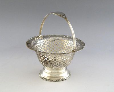 Appraisal: An Edwardian silver swing-handled basket of tapering circular form pierced