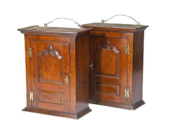 Appraisal: A pair of George III oak hanging cabinets mid th