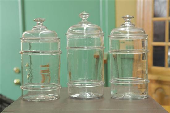 Appraisal: THREE BLOWN GLASS CANISTERS Colorless canisters with applied rings and