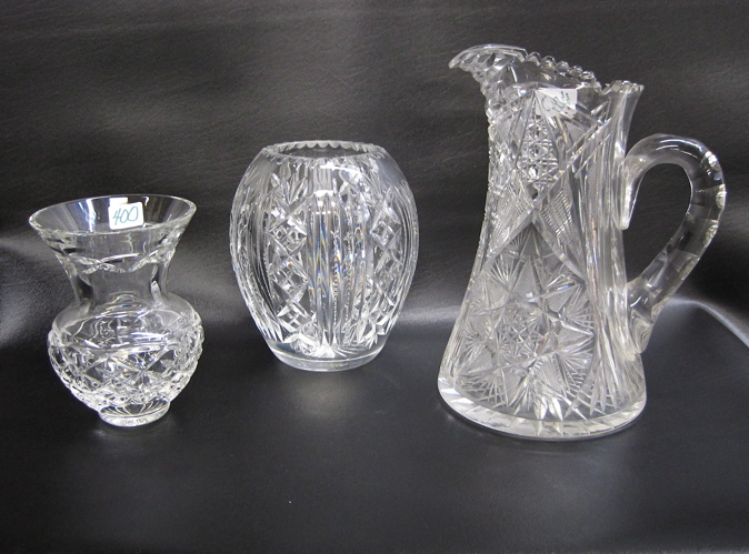 Appraisal: TWO CLEAR CUT GLASS VASES A PITCHER pieces The pitcher