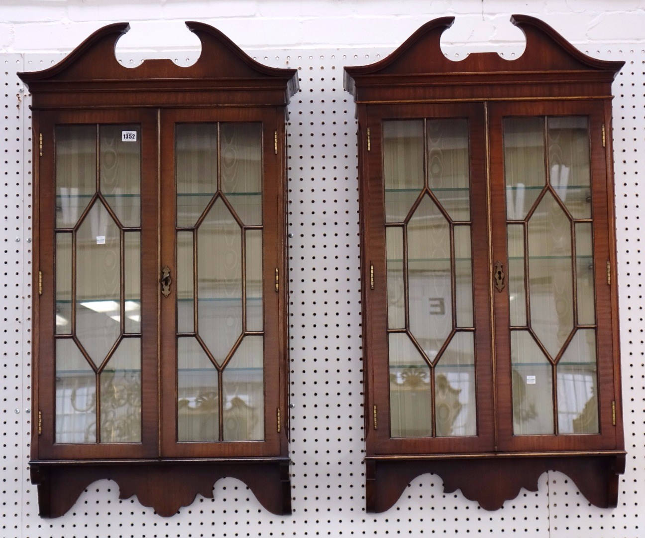 Appraisal: A pair of mid th century style mahogany hanging display