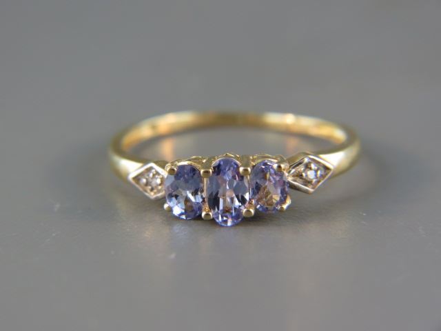 Appraisal: Tanzanite and Diamond Ring a trio of oval gems with