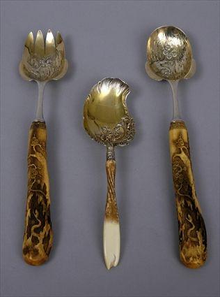 Appraisal: THEODORE B STARR TWO-PIECE JAPONAISE HORN-HANDLED SILVER GILT FRUIT SET